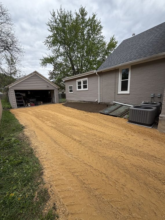 New gravel driveway laid between a house and detached garage