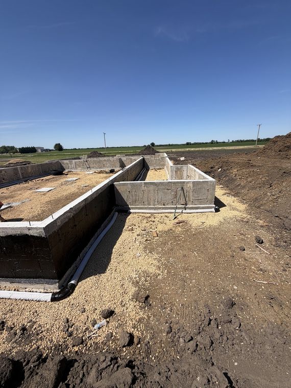 Poured foundation from grade level showing footings and drain tile