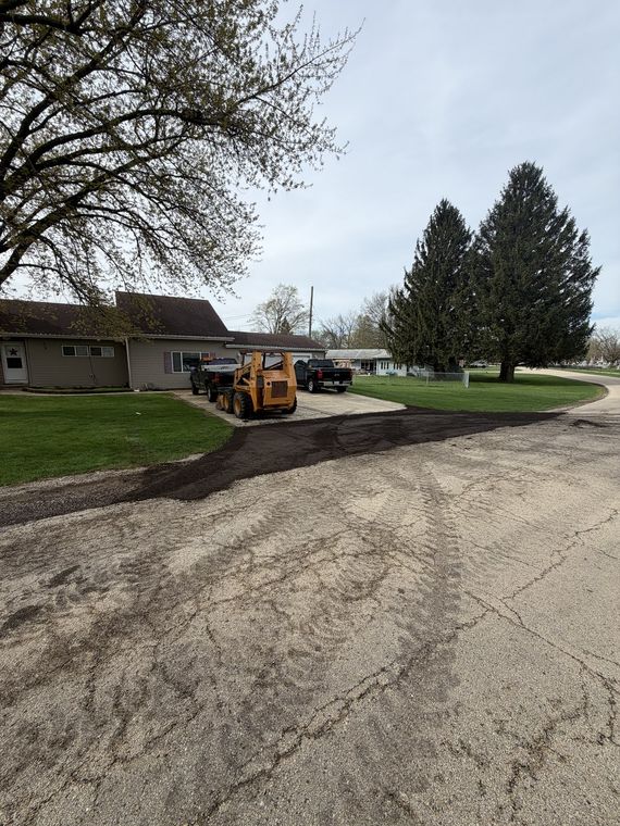 Gravel driveway approach regraded alongside a ranch house
