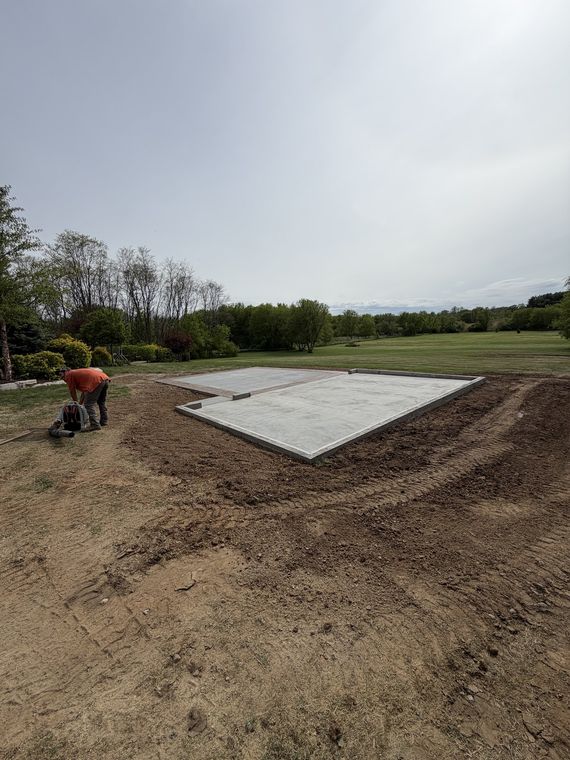Poured concrete pad with the surrounding ground graded smooth