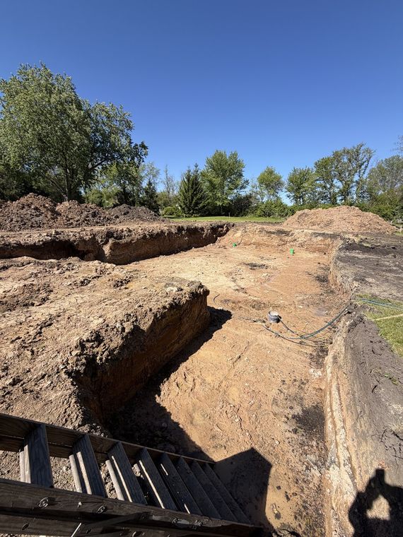 Deep foundation excavation with cut earth walls and an access ladder