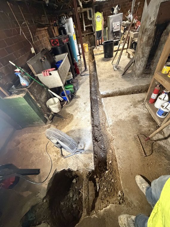 Interior basement trench cut through the slab for a new sewer line
