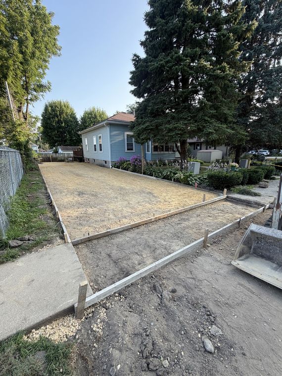 Driveway forms set over a compacted gravel base ready for concrete