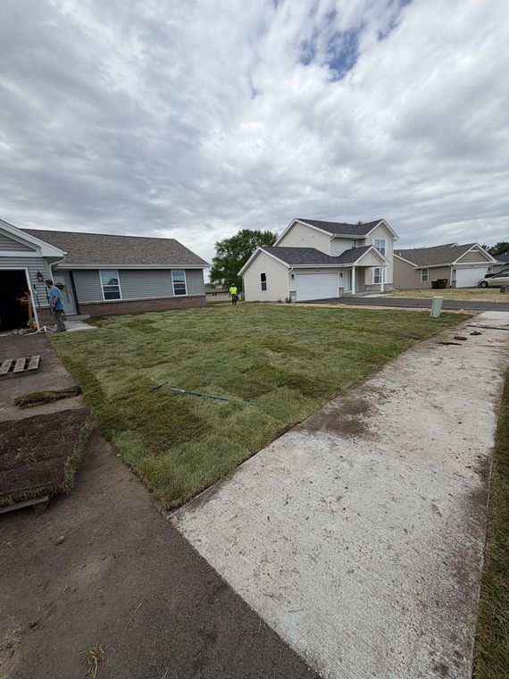 New construction lot with a finished concrete drive and fresh sod